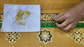 Thai patterns embroidery work with gold metallic yarn, the ancient ornamental clothes - Powered by Shutterstock - Get 15% off with code: PIKWIZARD15