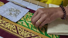 Thai patterns embroidery work with gold metallic yarn, the ancient ornamental clothes - Powered by Shutterstock - Get 15% off with code: PIKWIZARD15