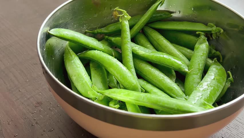 Green peas in pods in a bowl