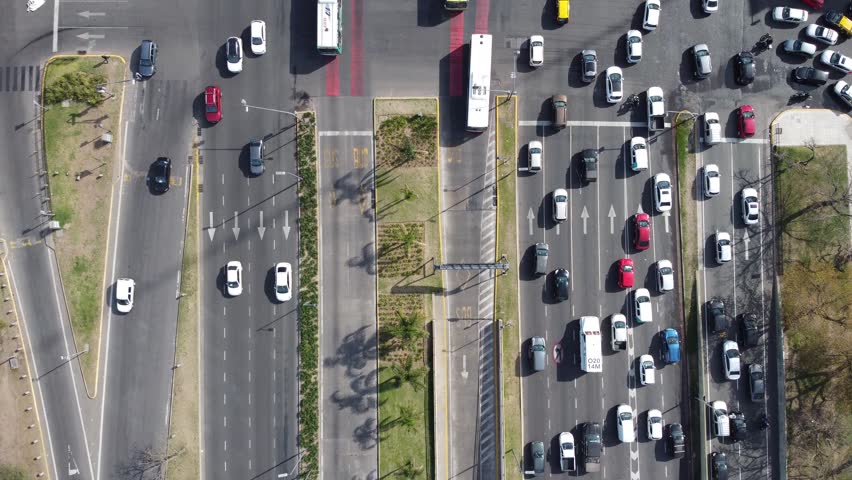 Overhead drone shots of 9 de Julio avenue in the city of Buenos Aires, with a lot of traffic passing by.