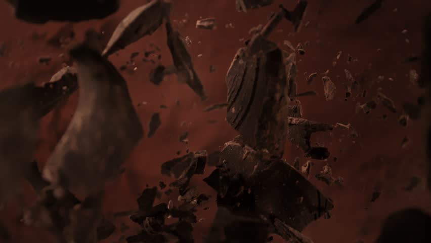 Super Slow Motion Shot of Chocolate Chunks Followed by Camera Falling into Cocoa Powder at 1000fps.