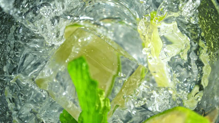 Super Slow Motion Shot of Ice Cube Falling into Glass with Lemonade at 1000fps with Camera Motion.