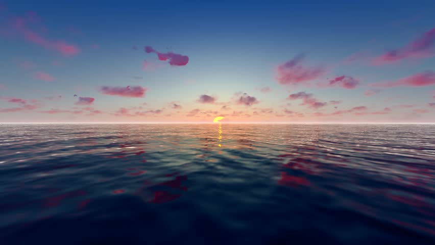 The sun slowly rises over the calm lake in the morning