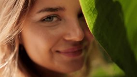  Face of young woman with clean skin with natural makeup among banana leaves. Natural beauty. Beautiful woman with charm looking at camera. Selective focus, wide open aperture. - Powered by Shutterstock - Get 15% off with code: PIKWIZARD15