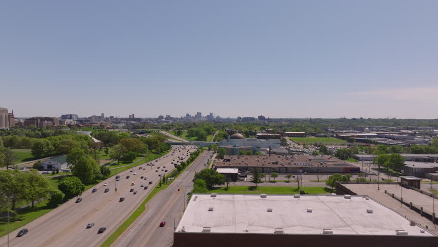 Aerial view of major roads heading to St Louis, green spaces, and urban structures under a clear blue sky of this city in the Midwest
