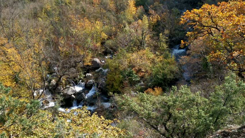 Mountain river top view. The rapid flow of the river rushes over the stones. Refreshing cool autumn landscape with the purest water. The concept of hiking, beauty. Taking care of the environment.