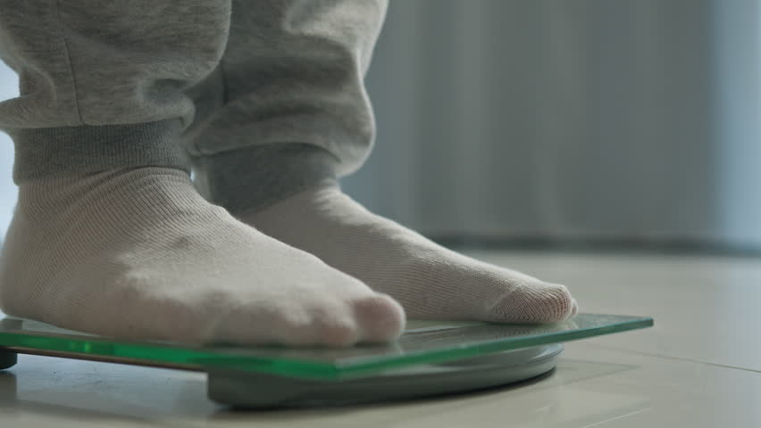 Man feet scales measuring losing weight male legs weighing stepping dieting health body mass digital device control counting wellness sport sportsman balance slimming flooring overweight obesity check