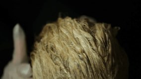 Woman at hairdresser bleaching hair