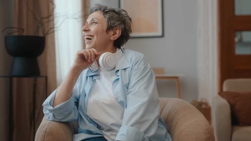 Calm relaxed elderly woman spending time at home