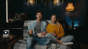 Scared couple watching horror movie in living room. - Powered by Shutterstock - Get 15% off with code: PIKWIZARD15