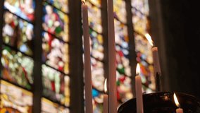 Candles burning in front of stained glass at St. Bavo's Cathedral, Ghent. - Powered by Shutterstock - Get 15% off with code: PIKWIZARD15