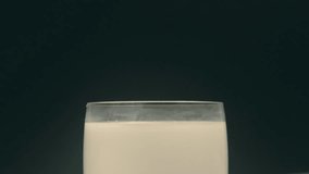Oreo cookie falling into glass of milk and splashing in slow motion - Powered by Shutterstock - Get 15% off with code: PIKWIZARD15