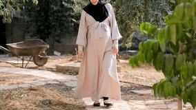 muslim pregnant female wearing hijab walking between trees and having fresh air for enjoying her time and clearing her mind - Powered by Shutterstock - Get 15% off with code: PIKWIZARD15