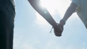 Close-Up of a Loving Young Couple Walking Hand-in-Hand on a Romantic Walk in Sunlit Park - Powered by Shutterstock - Get 15% off with code: PIKWIZARD15