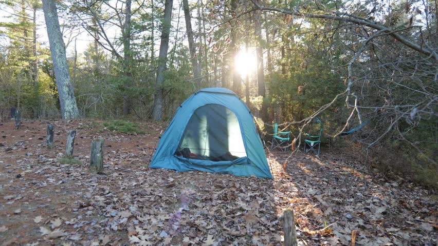 Timelapse of Sun Setting Behind Tent and Trees in the Woods in a Campground Near Alpena Michigan