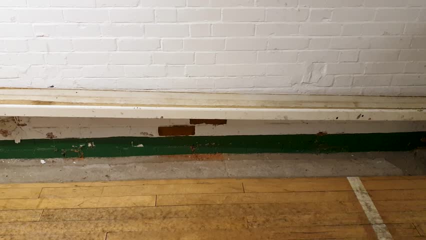 Three wooden balls rolling down ball shoot on traditional pub alley for a game of skittles