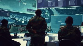 Woman army officer coordinating special operations mission in command post, monitoring surveillance satellite footage on big screen in military power base. Female soldier on duty. Camera B. - Powered by Shutterstock - Get 15% off with code: PIKWIZARD15