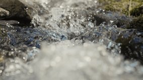 Slow motion of mountain river , stream flowing through rocks. Close up of river stones with flowing water, clean water flowing in a mountain river  - Powered by Shutterstock - Get 15% off with code: PIKWIZARD15