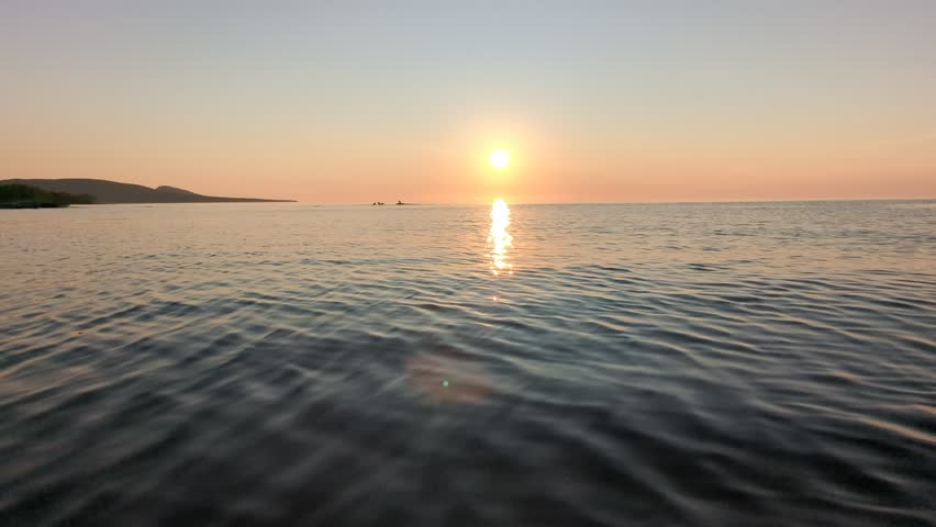 Sunset over Lake Superior in Michigan with the Porcupine Mountains in the background