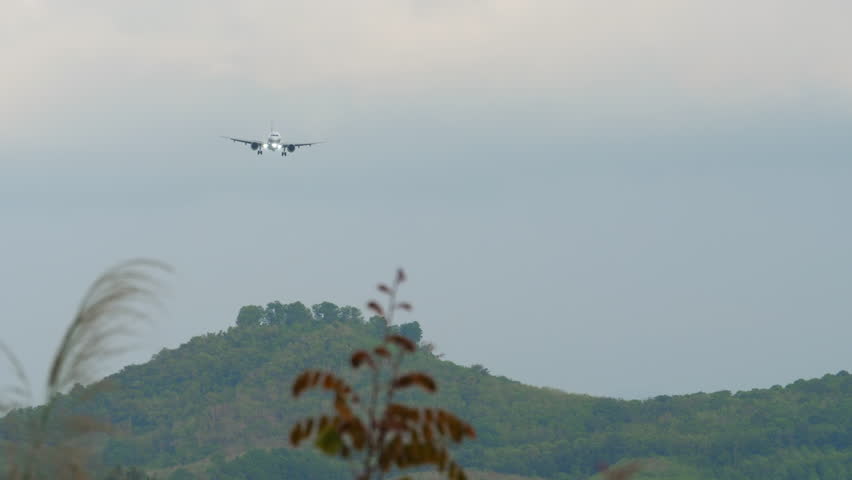 Shot, jet plane approaching landing. Airliner arriving. Airplane with headlights on in the sky