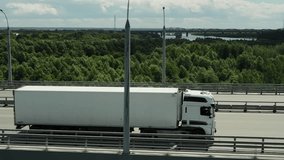 Long distance truck freight. Big lorry cargo transportation drone view from above. Large van drive city street highway. Road way logistic. Fast heavy semi trucks goods delivery. Trucker driver move. - Powered by Shutterstock - Get 15% off with code: PIKWIZARD15