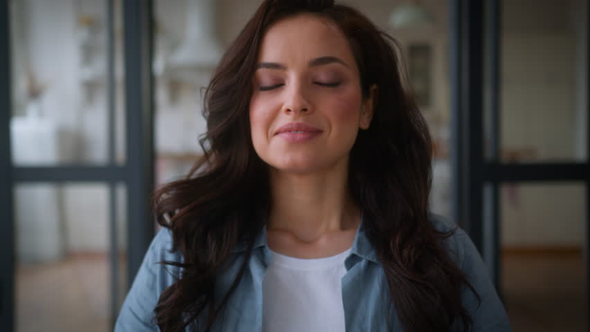 Happy Caucasian smiling woman practicing yoga calm peace lady female girl meditation at home sitting on couch in living room in lotus position relaxing with closed eyes mindful meditation health care