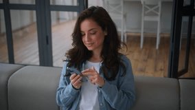 Caucasian smiling woman girl female at home couch sofa using mobile phone app shopping online reading news chatting social media web smartphone browsing buyer user internet chat booking order delivery - Powered by Shutterstock - Get 15% off with code: PIKWIZARD15