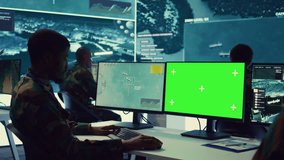 Intelligence analyst reviews ships activity next to an isolated mockup screen, following gps coordinates of vessels anchoring along the coastal ports. Army officer in monitoring room. Camera B. - Powered by Shutterstock - Get 15% off with code: PIKWIZARD15