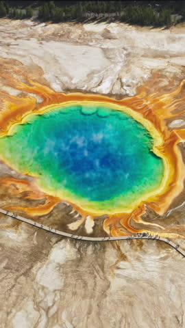 A mesmerizing aerial shot captures the vibrant colors of the Grand Prismatic Spring in Yellowstone Park, attracting tourists and nature lovers with its stunning beauty and natural wonder