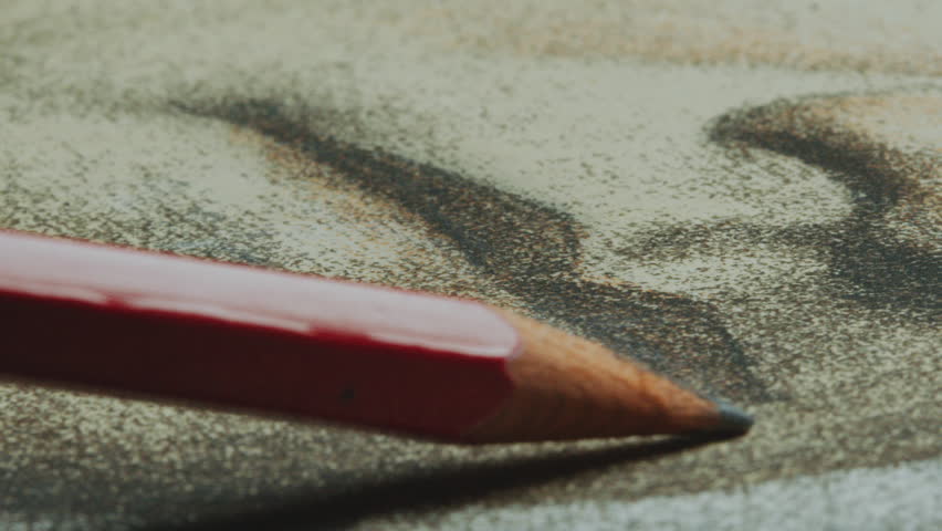 Unseen artist drawing lips with graphene pencil on paper while creating portrait. Close-up shot