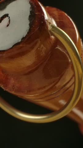 Old-style clean metal copper Cezve with great looking wooden handgrip. Macro dolly shot of coffee equipment. Vertical shot.