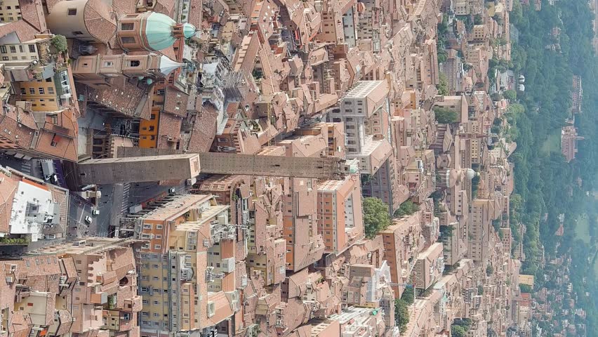 Vertical video. Bologna, Italy. Old Town. Two Towers. (Le due Torri) Garisenda and degli Asinelli. Towers from the 12th century. Summer, Aerial View, Point of interest
