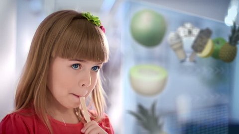 little girl selects healthy food on touchscreen monitor 