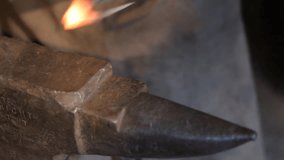 Blacksmith work. The blacksmith makes arrow from metal.