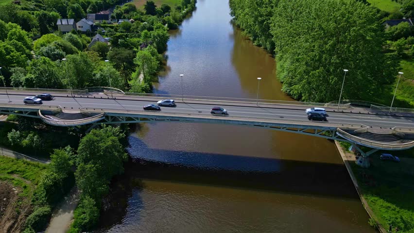 Pont de Pritz bridge over Mayenne River, border between Laval and Changé, France. Aerial forward tilt-up reveal