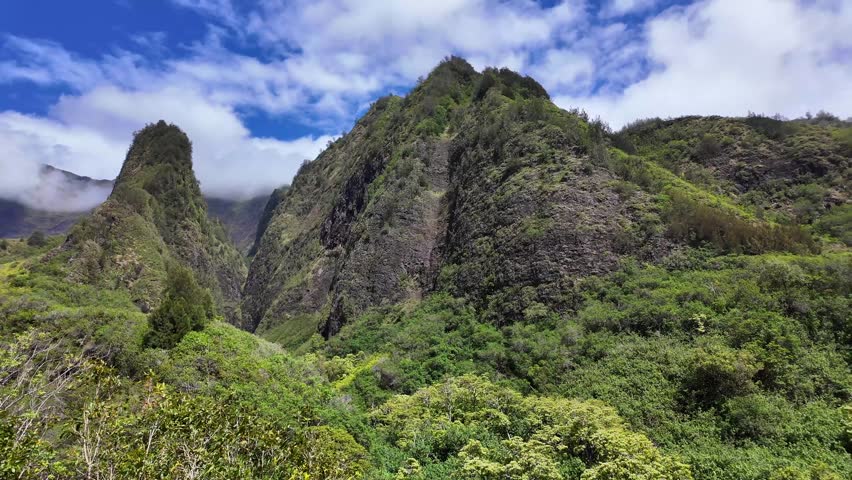 Īao Valley is a lush, stream-cut valley in West Maui, Hawaii, located 3.1 miles west of Wailuku.