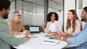 A lively team discussion unfolds in a modern office, where diverse colleagues share ideas with confidence, planning together, signifying a dynamic and inclusive workplace - Powered by Shutterstock - Get 15% off with code: PIKWIZARD15