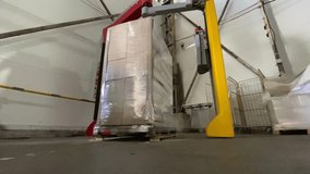 The boxes on the pallet are wrapped with film. Equipment for packing large pallets. Oilcloth packaging of humanitarian aid packages in Ukraine. High quality 4k video - Powered by Shutterstock - Get 15% off with code: PIKWIZARD15