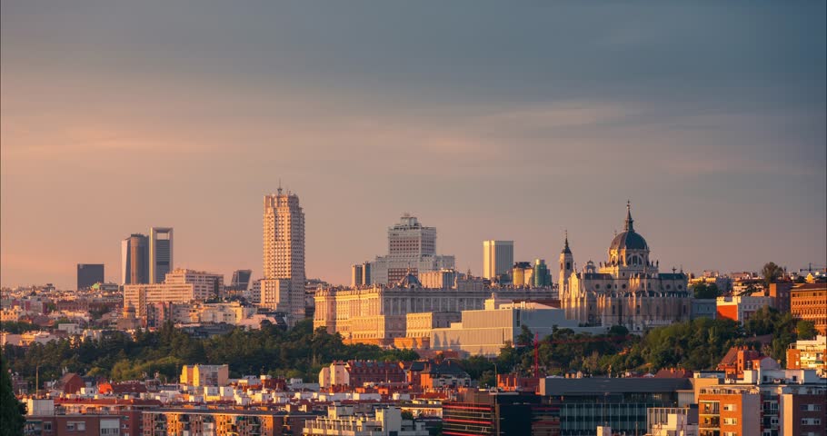 day to night timelapse of Madrid historical skyline beautiful light and sunset Almudena cathedral, Royal Palace and Plaza España buildings