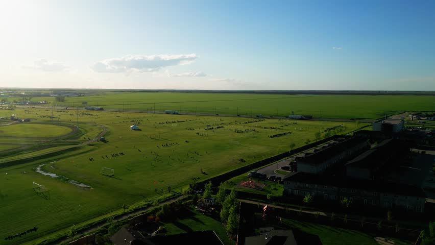 The Sun Sets on People Playing on an Outdoor Soccer Field Park in the Countryside of Winnipeg Manitoba Canada