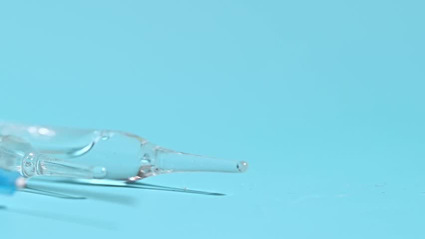 syringe close-up in the studio on a blue background
