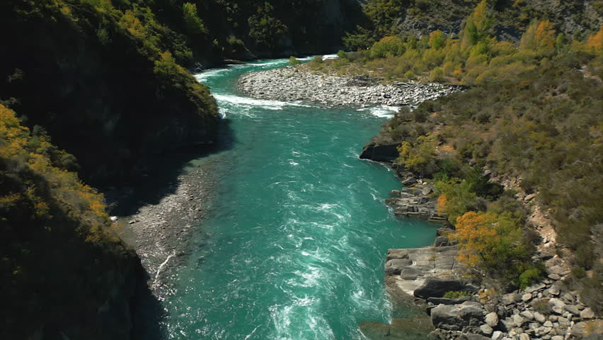 Flying through valley following famous Kawarau River, Queenstown, New Zealand.