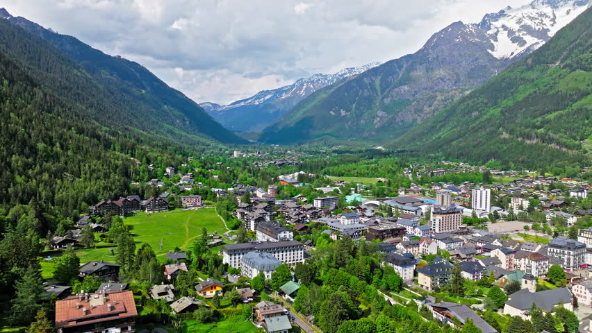 Aerial Panoramic view of the resort area Chamonix Valley in the heart of the French Alps. French traditional houses with layers of steeply peaked roofs, dormer windows and tall chimneys in France.