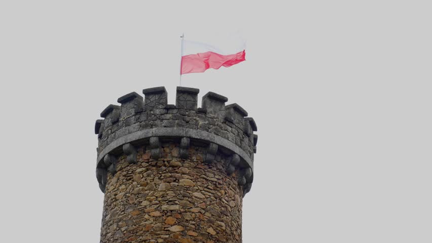  Polish Flag on the Tower. The white-red flag is developing beautifully in the wind against the gray sky. 