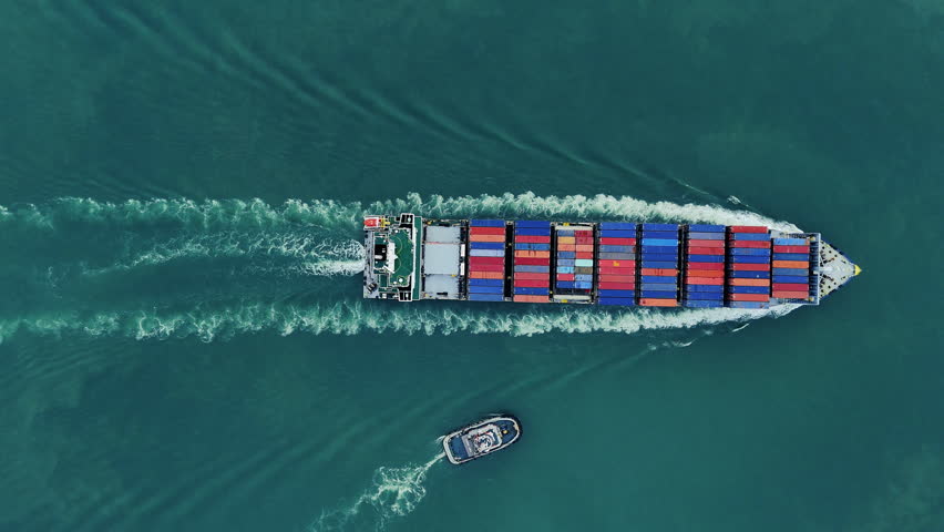 top view of Cargo container ship carrying container and running out international container port customs shipyard sea port concept smart logistic service. 