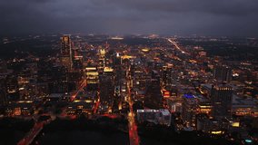 Vibrant lights of Austin's downtown skyline at dusk with twinkling buildings, busy streets, and a stunning aerial perspective