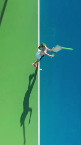 Vertical Screen: A tennis player demonstrates athleticism during an exhilarating match on a blue court, showcasing dynamic movement and skilled play while embodying vigor and sportsmanship