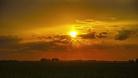 Time lapse sunset moving clouds and sun beautiful field landscape golden sky - Powered by Shutterstock - Get 15% off with code: PIKWIZARD15