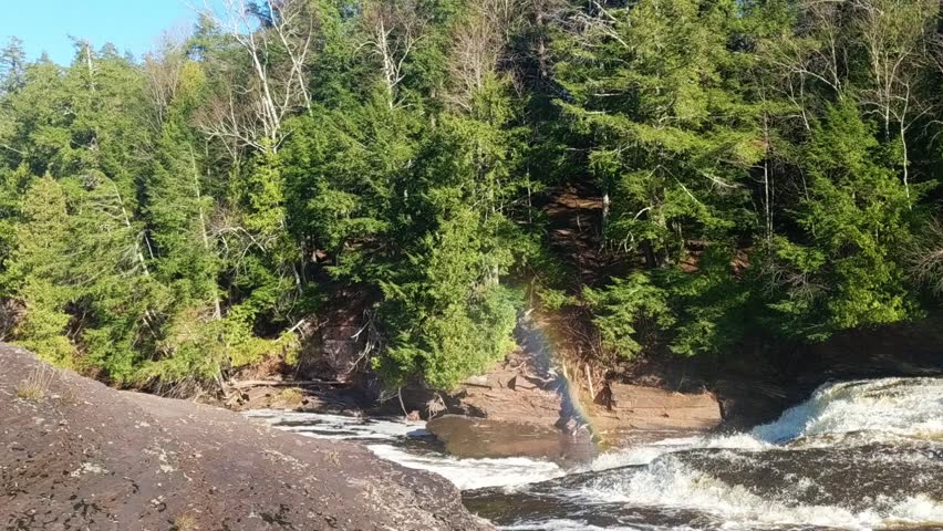 Rainbow in the mists of a waterfall at Porcupine Mountains Wilderness State Park in Michigan
