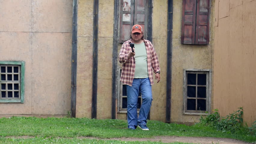 a male tourist walks through the old town with a camera